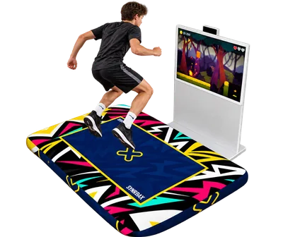 Player jumping on a Crazy Trampoline mat beside an interactive game screen